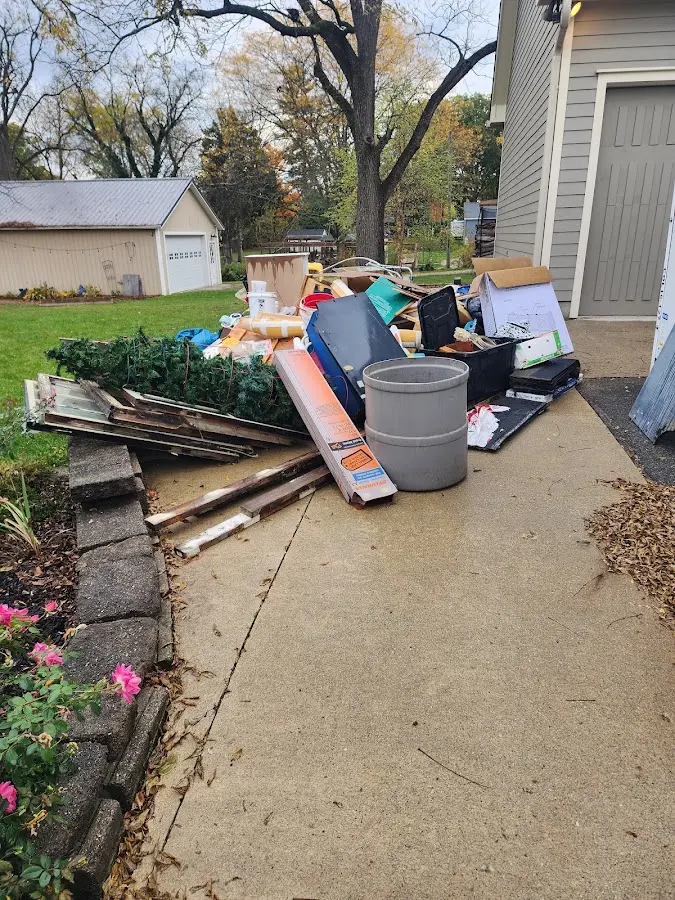 Dumpster being loaded with debris for 10 Yard Dumpster Rental in Sandpoint